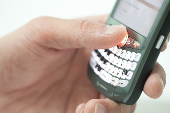 Photo of a hand holding a cell phone