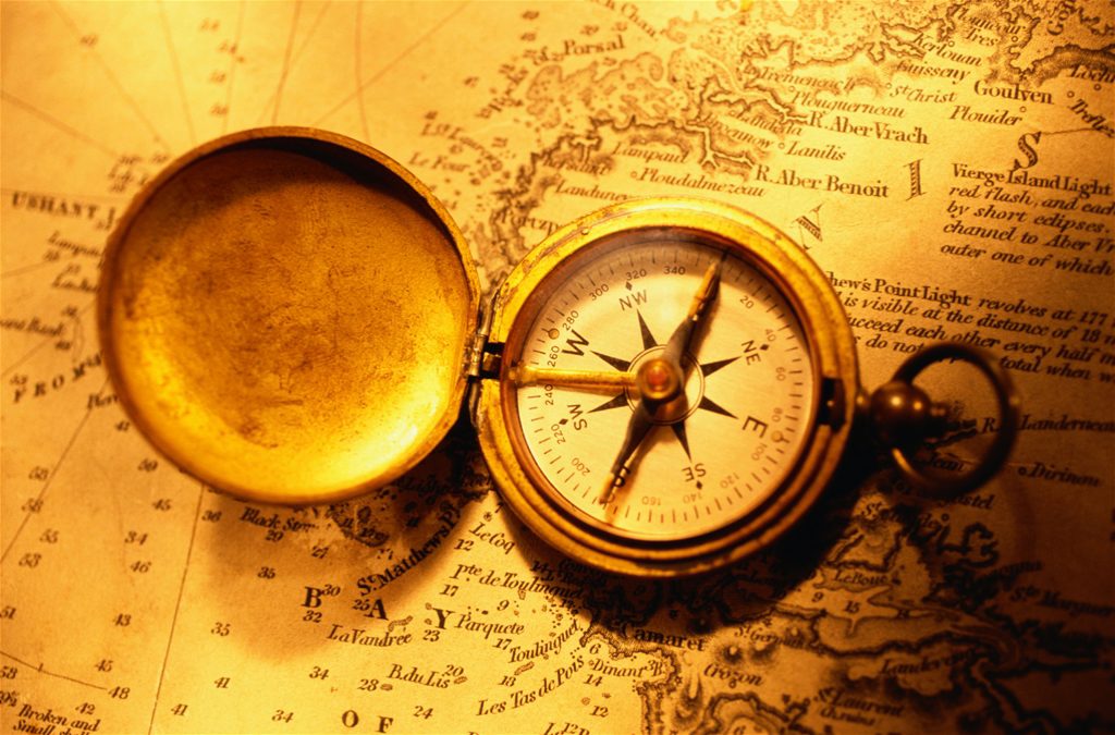Photo of an antique compass on a map