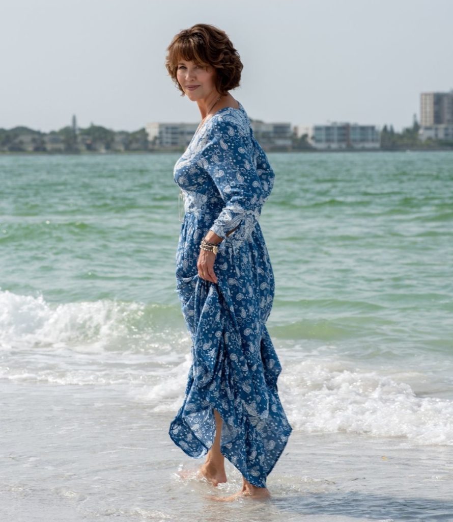 Photo of Darlene Coleman wading at the water's edge on a Sarasota beach