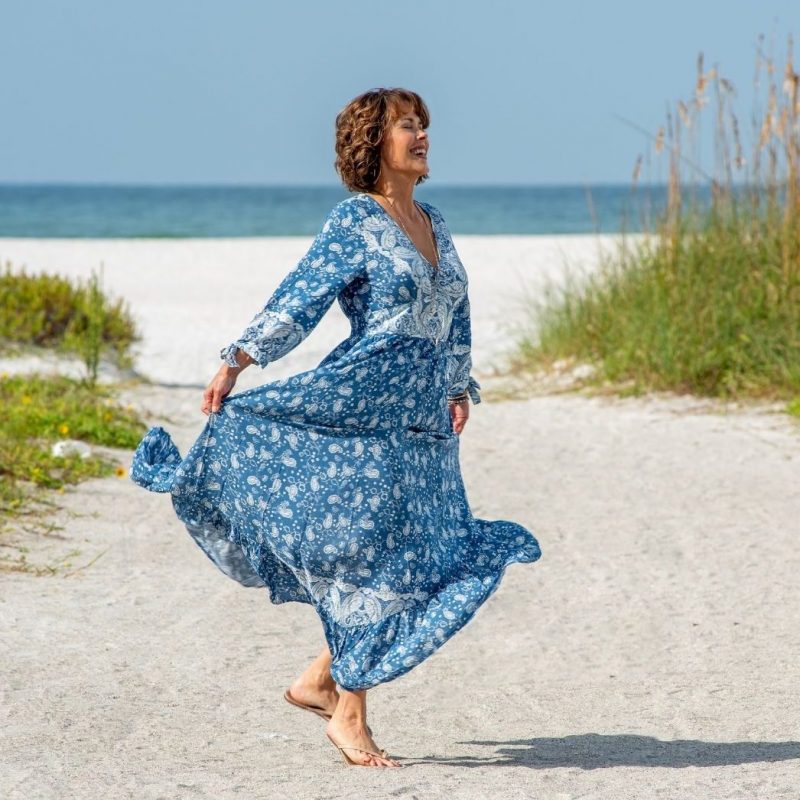 Photo of Darlene Coleman dancing on a Sarasota beach